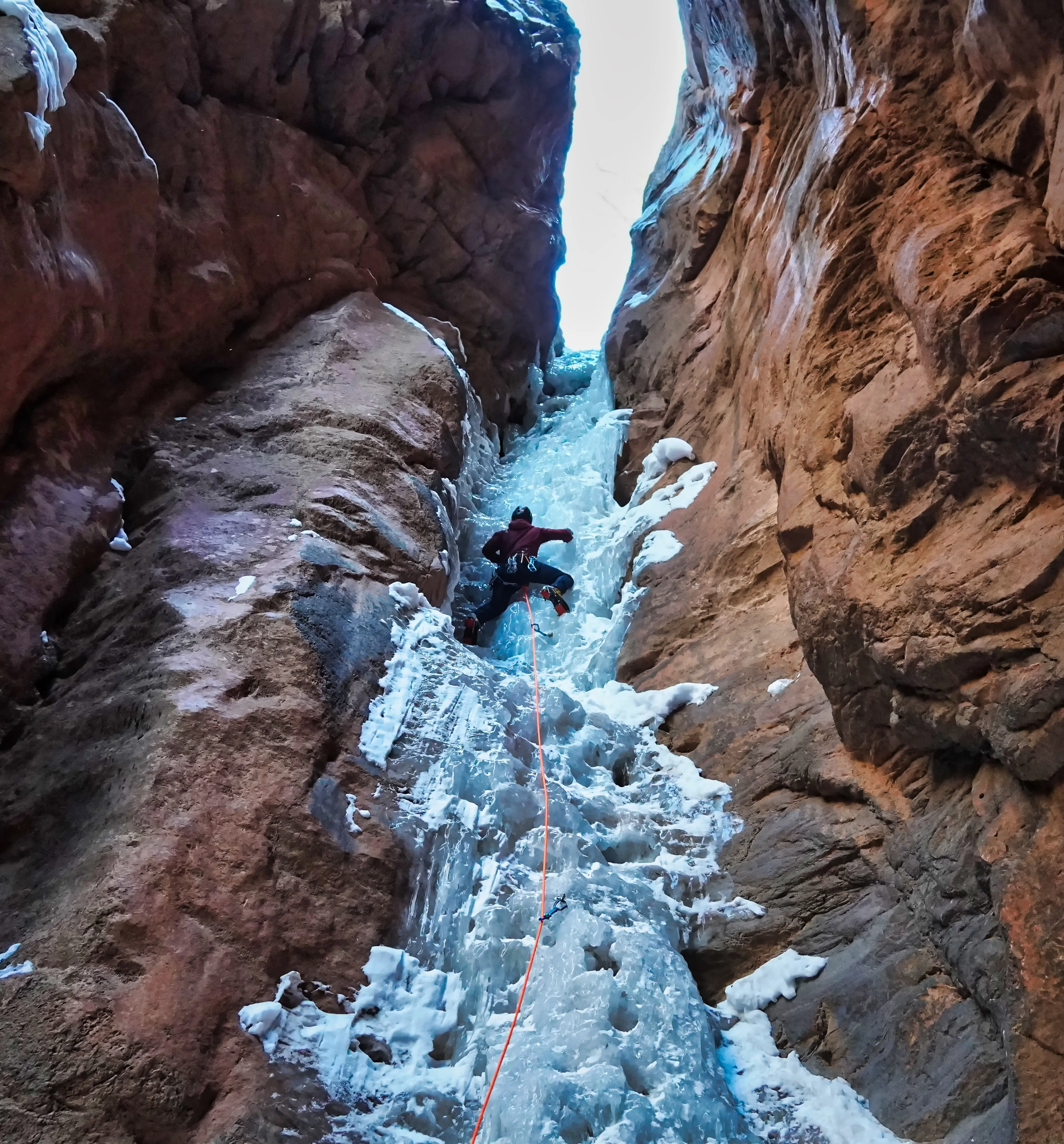Cooper Stewart climbing the aesthetic last pitch of Hidden Haven. Southern Utah. Outdoor photographer Shane Haynes