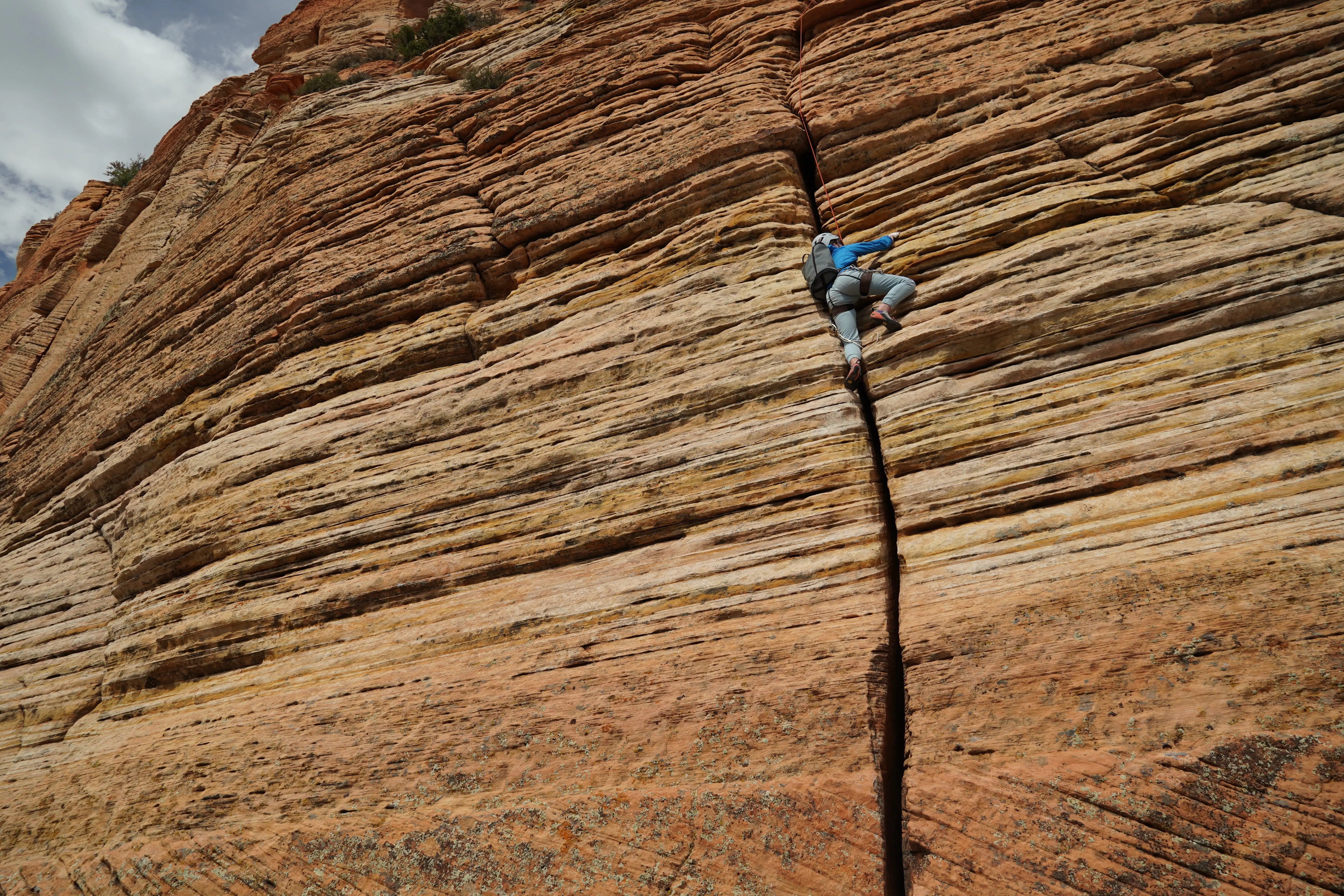 Jordan Evans climbing a crack on Cowboy Ridge, just outside Zion National Park. Outdoor photographer Shane Haynes